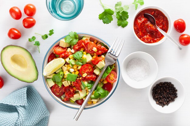 Healthy vegan avocado sweetcorn tomato salad