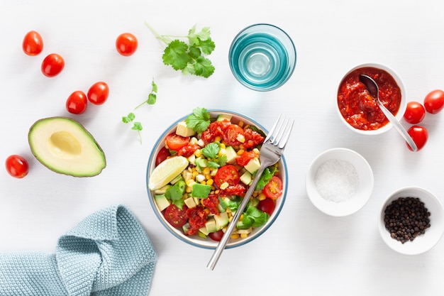 Healthy vegan avocado sweetcorn tomato salad