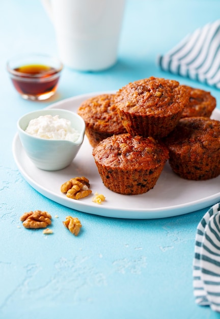 Healthy vegan carrot muffins with riccota cheese on a plate Blue stone background