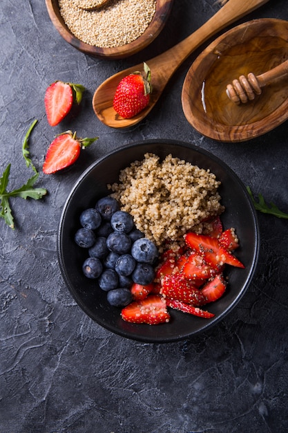 Healthy vegan diet salad quinoa with blueberry,strawberry, honey and chia seeds. 