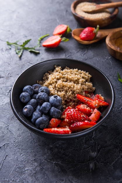 Healthy vegan diet salad quinoa with blueberry,strawberry, honey and chia seeds. 