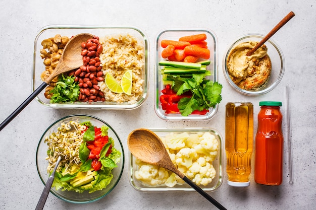 Healthy vegan food in glass containers, top view. 