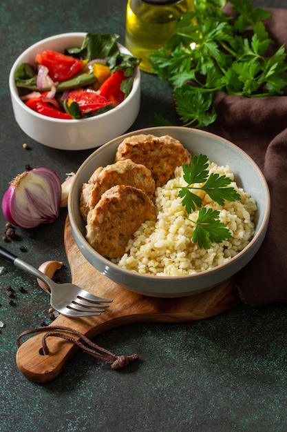 Healthy vegan food Red fish cutlets with bulgur and fresh vegetable salad Copy space