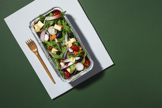 Healthy vegan Take away salad in aluminum container or food delivery. From above