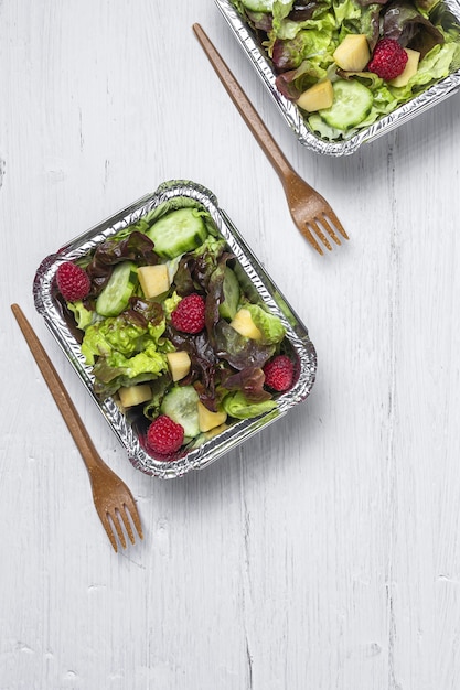 Healthy vegan Take away salad in aluminum container or food delivery.