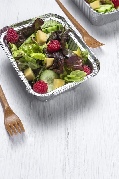 Healthy vegan Take away salad in aluminum container or food delivery.