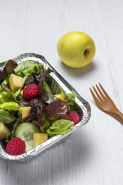 Healthy vegan Take away salad in aluminum container or food delivery.