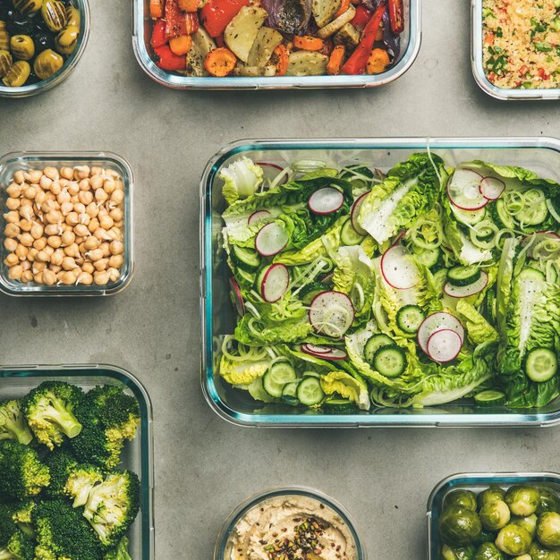 healthy vegan or vegetarian dishes in glass containers square crop