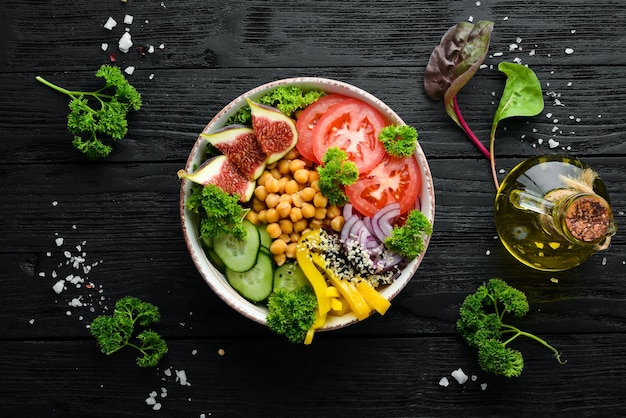 Healthy vegetable buddha bowl lunch with chickpeas figs cucumber tomatoes and onions Dishes menu Free copy space Top view