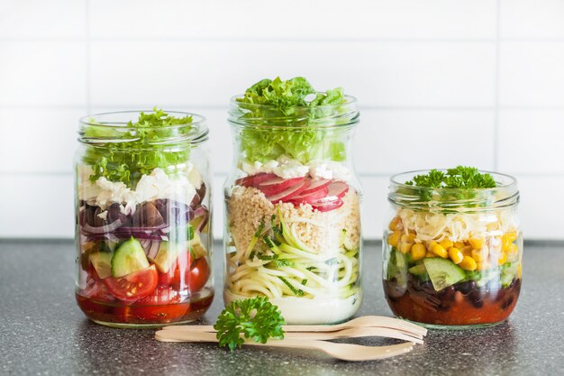 Healthy vegetable cheese salad in mason jars