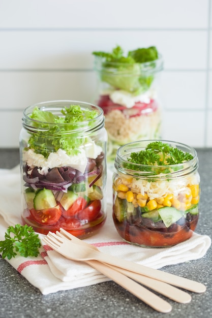 Healthy vegetable cheese salad in mason jars