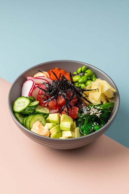 Healthy vegetable salad in black bowl green salad buddha bowl\
slate background