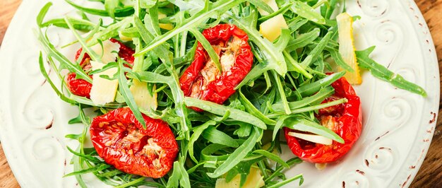 Healthy vegetable salad of sun dried tomato and arugula.Diet menu