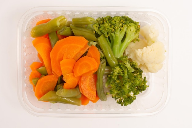 Healthy vegetables packed lunch box meal in front top aerial view clean white background