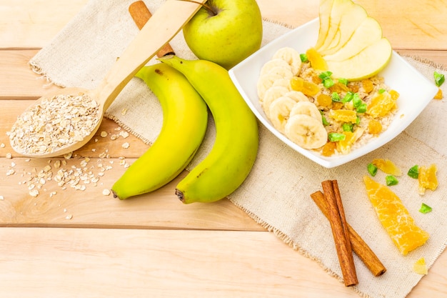 Healthy vegetarian breakfast with oatmeal and fruits