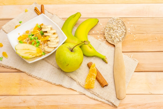 Healthy vegetarian breakfast with oatmeal and fruits