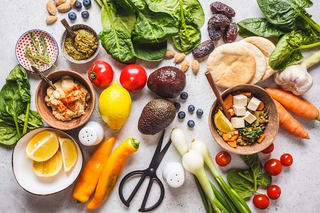 Healthy vegetarian food background. Vegetables, pesto and lentil curry with tofu.