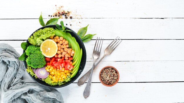 Healthy vegetarian food Bowl Buddha Avocados broccoli turkey peas corn Top view Free space for your text