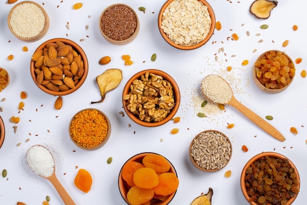 Healthy vegetarian food concept Assortment of dried fruits nuts and seeds on white background