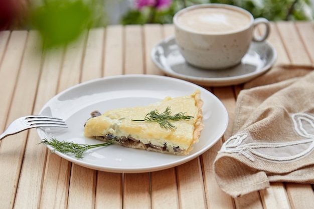 Healthy vegetarian homemade pie with mushrooms with cheese Cup of coffee lunch or breakfast Italian food
