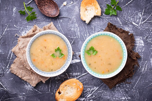 Healthy vegetarian peas soup on concrete background