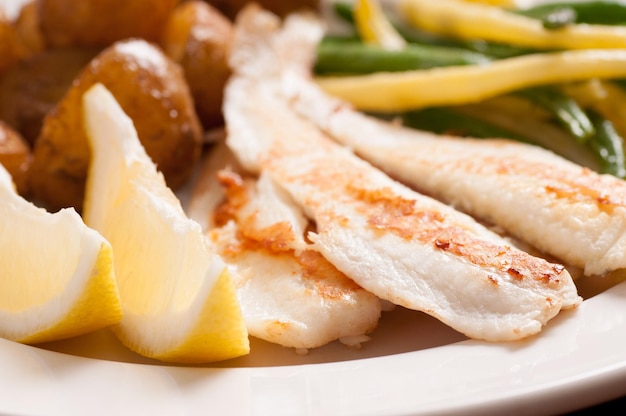 Healthy white fish fillets with vegetables