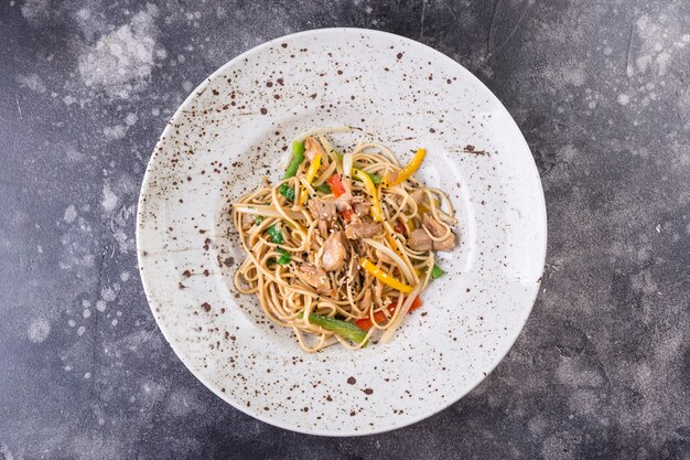 Healthy whole grain spaghetti with chicken and vegetables, pasta is a traditional Italian dish.