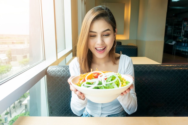 healthy woman holding vegetables salad 