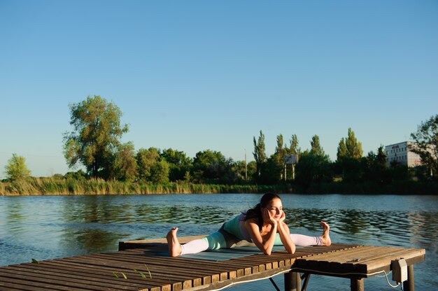 Healthy woman lifestyle balanced practicing meditate and energy yoga on the bridge in morning the nature.