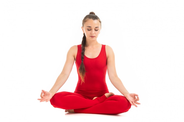 Healthy woman in red t-short and leggins is relaxed and meditating