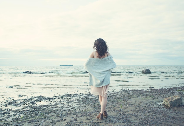 Healthy Woman Resting on Blue Sea and Sky Background Outdoors