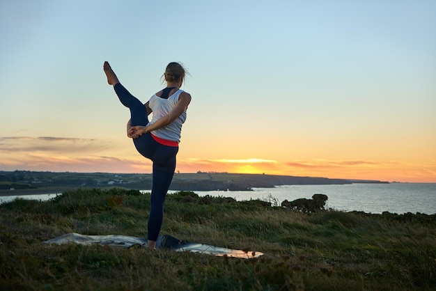 Healthy woman in yoga class doing exercise outdoor