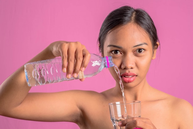 Healthy young asian latin woman with water. 