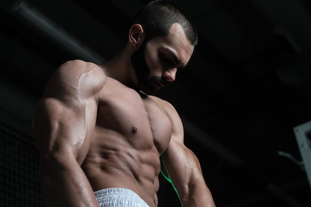 Healthy Young Man Flexing Muscles