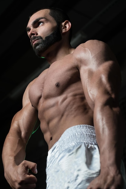 Healthy Young Man Flexing Muscles