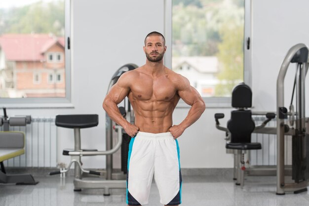 Healthy Young Man Flexing Muscles