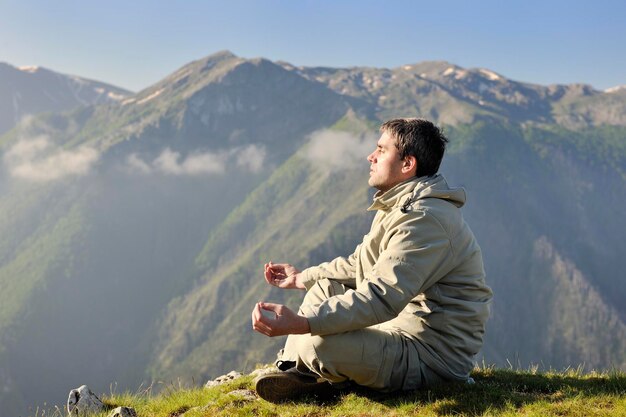 healthy young man practice youga in height mountain at early morning and sunrise