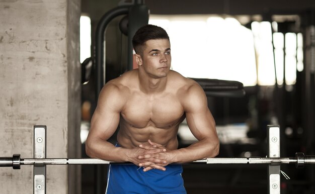 Healthy Young Man Resting In Healthy Club Gym After Exercising