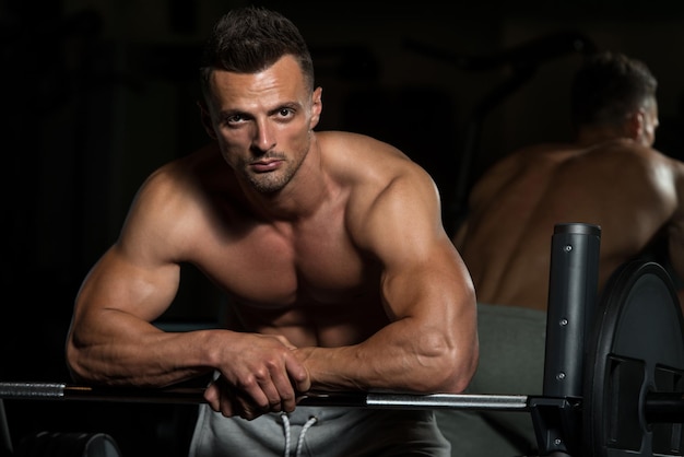 Healthy Young Man Resting In Healthy Club Gym After Exercising