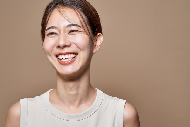 Healthy young woman and beige background