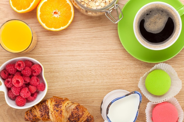 Healty breakfast with muesli berries orange juice coffee and croissant