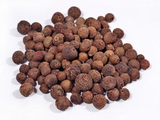 Heap of allspice on a white background