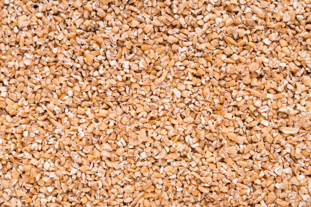 Heap of barley seeds background, top view, closeup