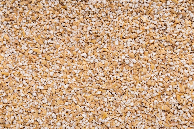 Heap of barley seeds background, top view