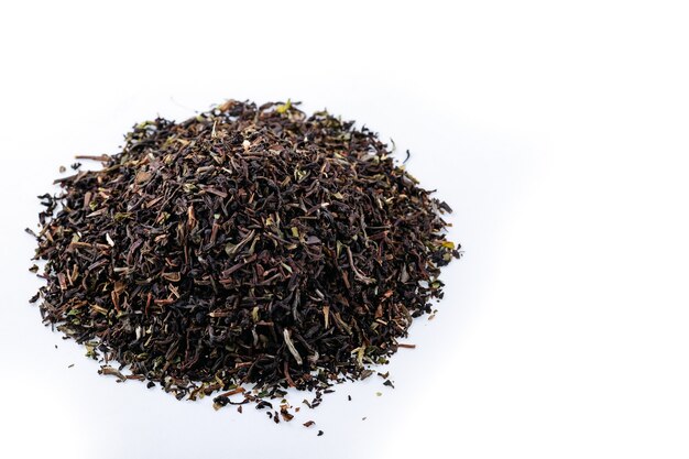 Heap of black tea on a white background