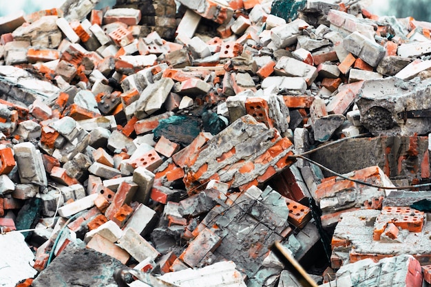 Heap of bricks and a destroyed building after demolition