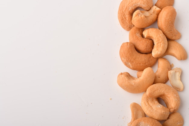 Heap of cashew nuts isolated on white surface