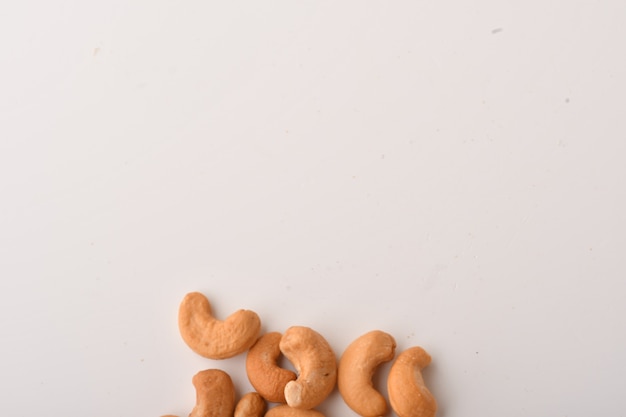 Heap of cashew nuts on white