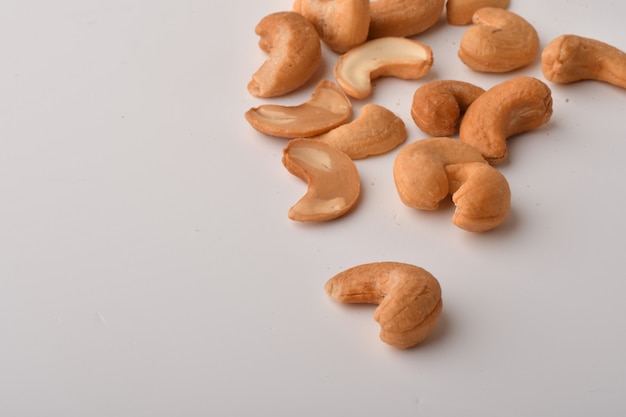 Heap of cashew nuts on white