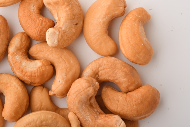 Heap of cashew nuts on white